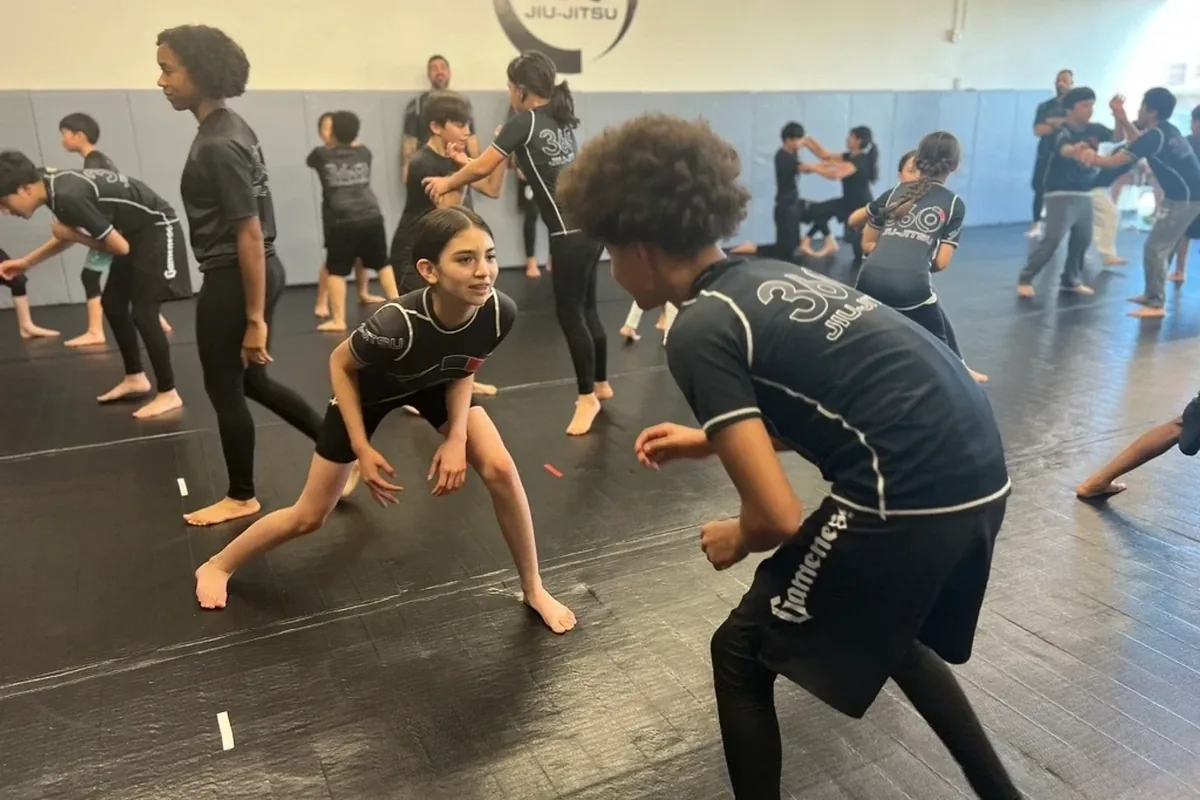 Adults sparring during open mat